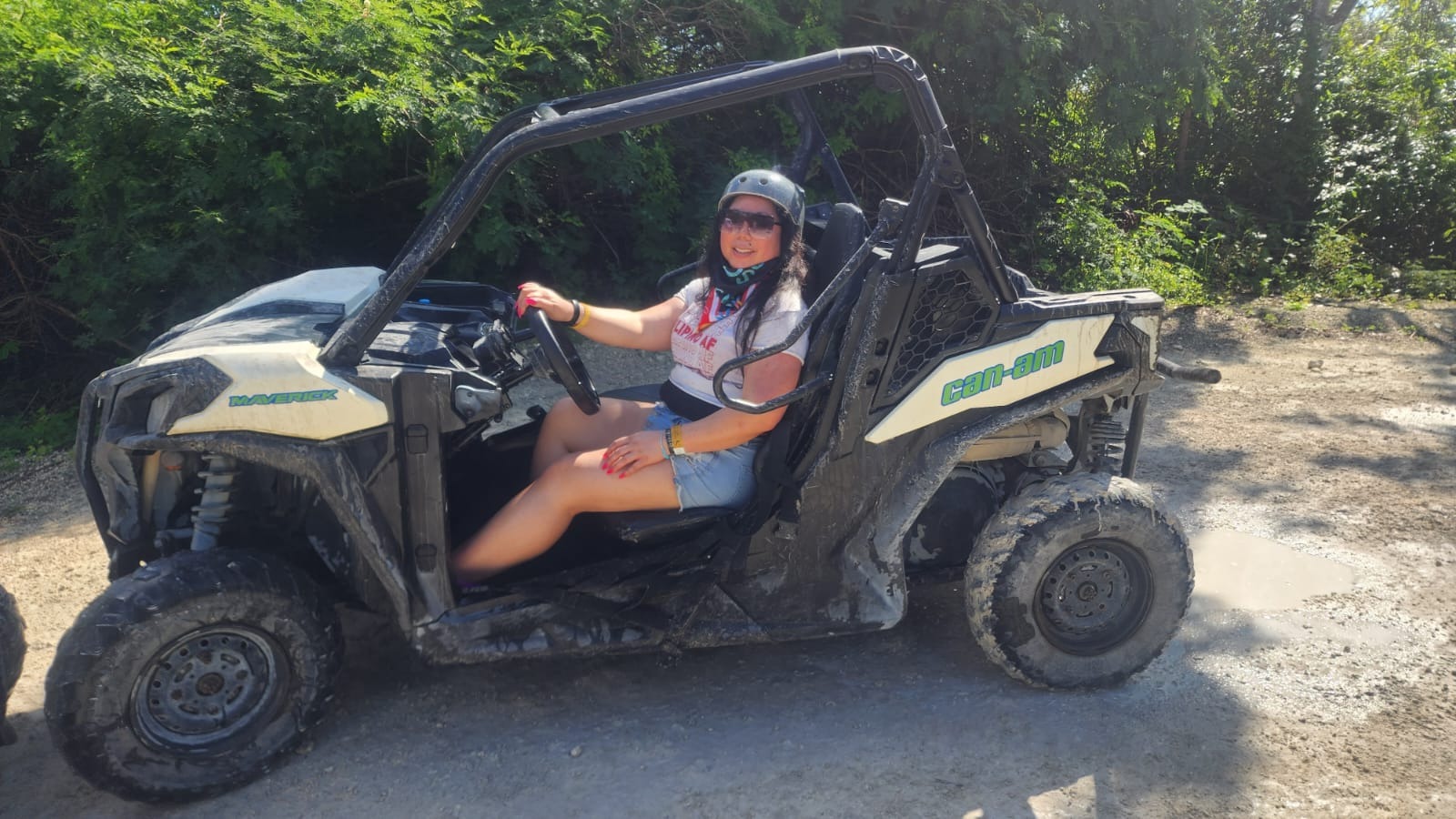 Marie wearing a helmet and sitting at the wheel of an off-road buggy